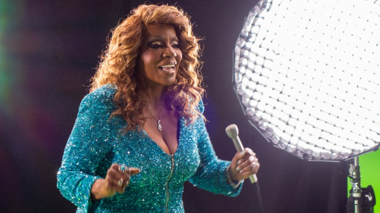 Singer Gloria Gaynor performing in a film studio setting